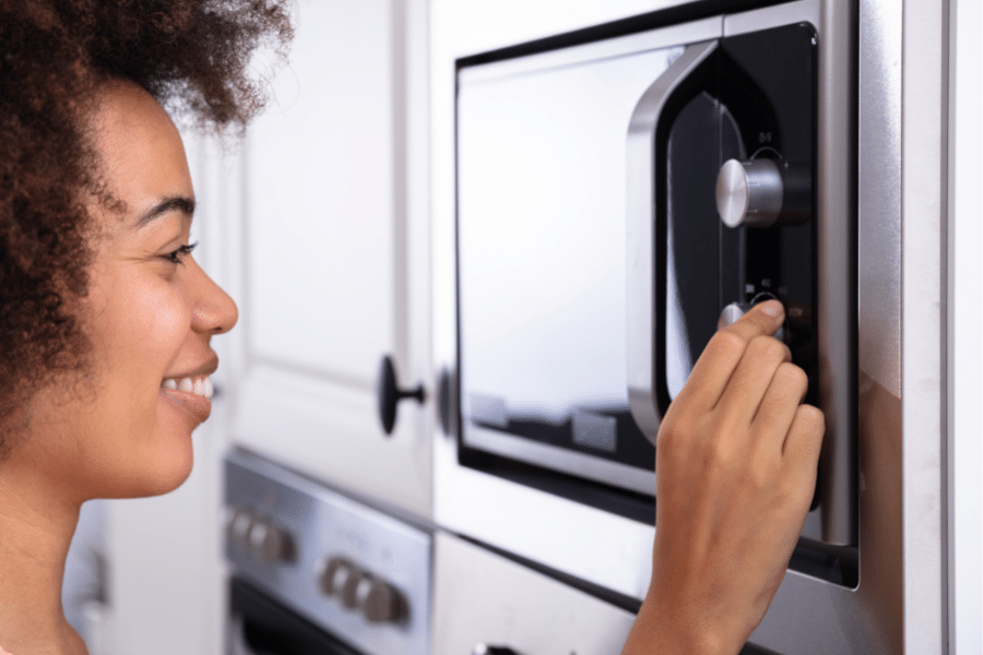 Woman Setting Microwave for Decarboxylation